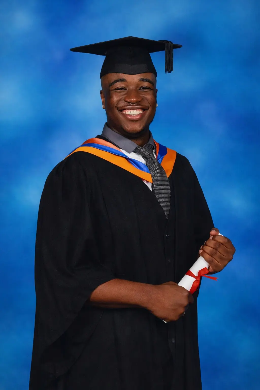 Idris Kadri wearing graduation robes
